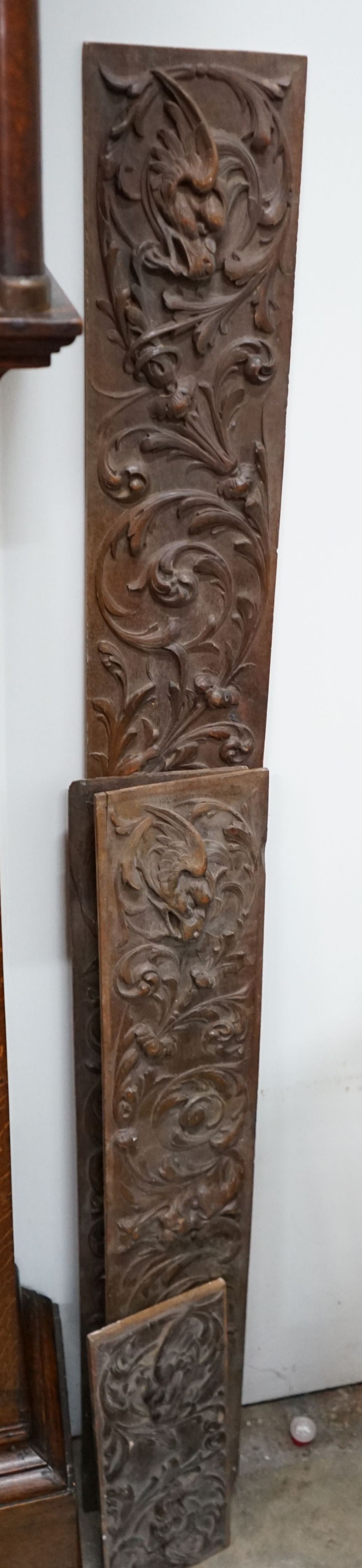 Four rectangular carved oak panels, largest length 152cm